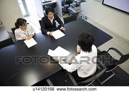 Stock Photo - Three people meeting at table. Fotosearch
