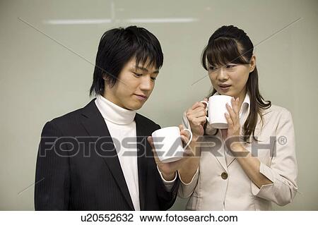 Stock Image - Two people having a coffee break. Fotosearch