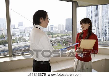 Stock Photograph - Two person meeting by the window. Fotosearch