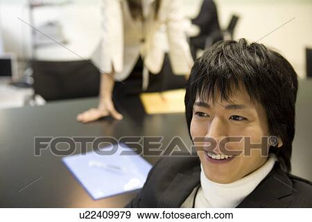 Stock Photo - Young businessman smiling. Fotosearch
