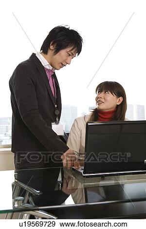 Stock Photo - Young man and woman meeting at table. Fotosearch