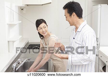 Mature couple standing in kitchen View Large Photo Image Stock Image - Mature couple standing in kitchen. Fotosearch
