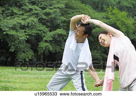 Stock Image - Mature couple stretching. Fotosearch