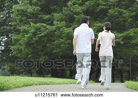 Mature couple walking View Large Photo Image Stock Image - Mature couple walking. Fotosearch