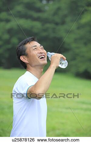 Mature man drinking water View Large Photo Image Stock Photograph - Mature man drinking water. Fotosearch