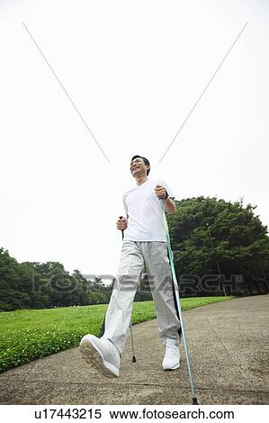 Mature man enjoying Nordic walking View Large Photo Image Stock Photography - Mature man enjoying Nordic walking. Fotosearch