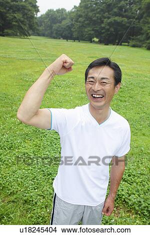 Mature man flexing muscles View Large Photo Image Picture - Mature man flexing muscles. Fotosearch