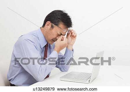 Mature man getting eyestrain View Large Photo Image Stock Photo - Mature man getting eyestrain. Fotosearch