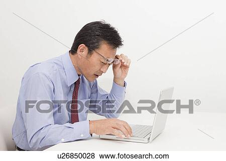 Stock Photo - Mature man looking computer. Fotosearch