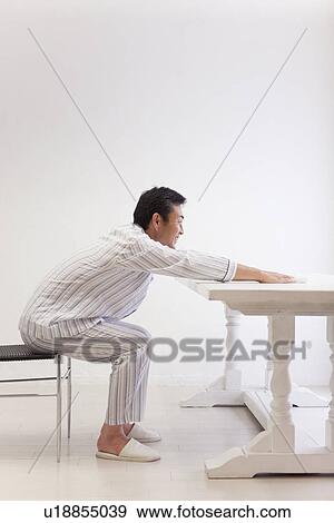Stock Photo - Mature man stretching shoulder. Fotosearch