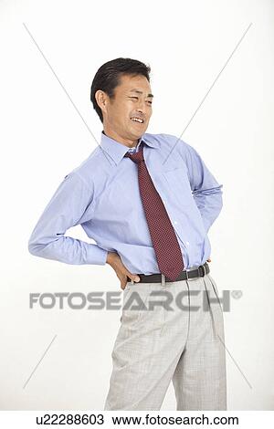 Mature man suffering from pain on back View Large Photo Image Stock Image - Mature man suffering from pain on back. Fotosearch