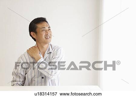 Mature man suffering from pain on shoulder View Large Photo Image Stock Photo - Mature man suffering from pain on shoulder. Fotosearch
