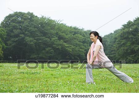 Picture - Mature woman stretching. Fotosearch