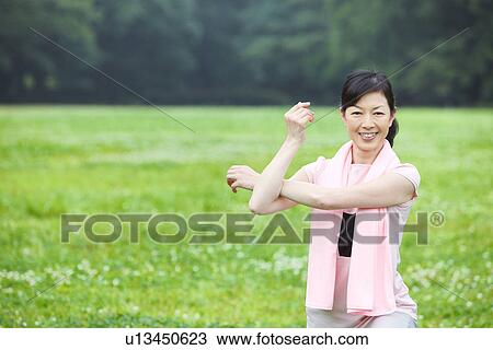 Stock Image - Mature woman stretching. Fotosearch