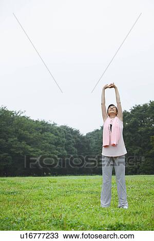 Stock Image - Mature woman stretching. Fotosearch