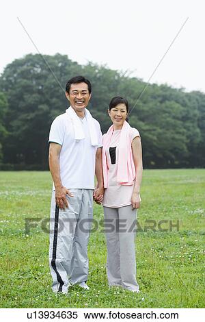 Stock Photography - Portrait of mature couple in sportswear. Fotosearch