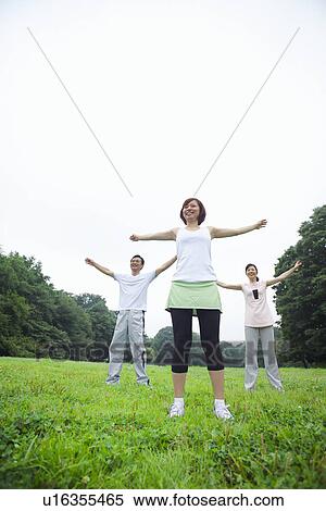 Three people stretching View Large Photo Image Stock Photography - Three people stretching. Fotosearch