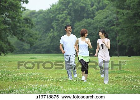 Stock Photography - Three people walking. Fotosearch