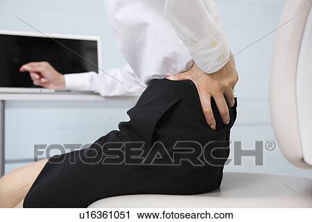Stock Image - Mid adult businesswoman exhausted. Fotosearch