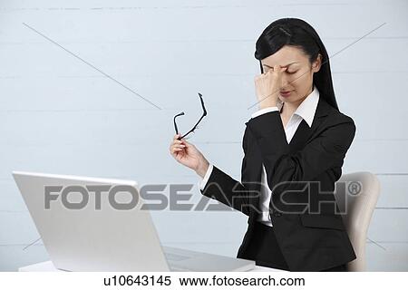 Mid adult businesswoman getting eyestrain View Large Photo Image Stock Photography - Mid adult businesswoman getting eyestrain. Fotosearch