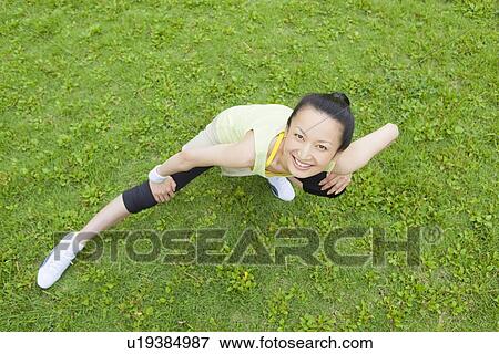 Stock Photo - Mid adult woman stretching. Fotosearch