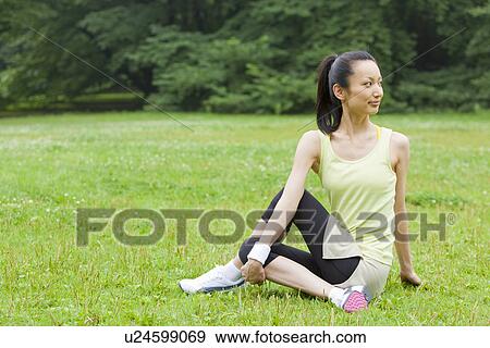 Mid adult woman stretching View Large Photo Image Stock Photo - Mid adult woman stretching. Fotosearch