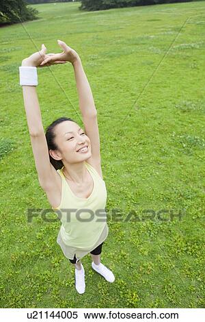 Mid adult woman stretching View Large Photo Image Stock Photography - Mid adult woman stretching. Fotosearch