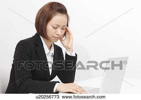 Young businesswoman suffering from headache View Large Photo Image Stock Image - Young businesswoman suffering from headache. Fotosearch