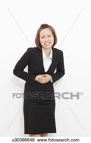 Young businesswoman suffering from stomachache View Large Photo Image Stock Photo - Young businesswoman suffering from stomachache. Fotosearch