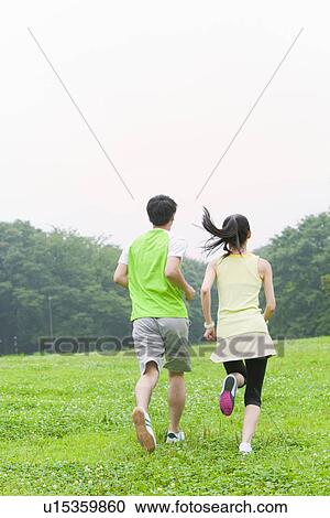 Young man and mid adult woman running View Large Photo Image Stock Image - Young man and mid adult woman running. Fotosearch