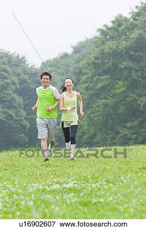 Young man and mid adult woman running View Large Photo Image Stock Photo - Young man and mid adult woman running. Fotosearch