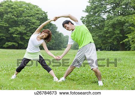 Young man and woman stretching View Large Photo Image Stock Image - Young man and woman stretching. Fotosearch