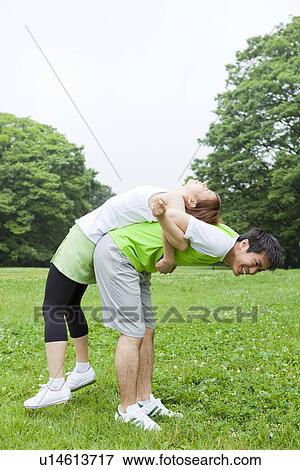 Young man and woman stretching View Large Photo Image Stock Photo - Young man and woman stretching. Fotosearch