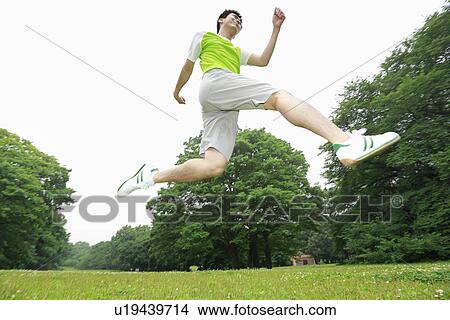 Picture - Young man jumping. Fotosearch