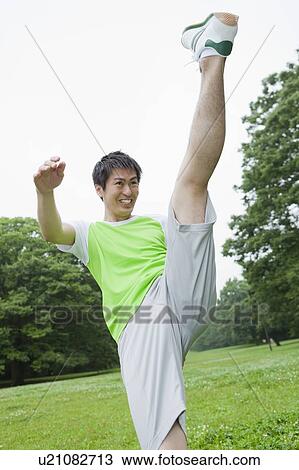 Stock Image - Young man kicking up. Fotosearch