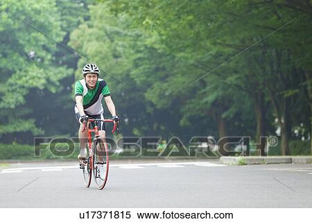 Young man riding bicycle View Large Photo Image Stock Photography - Young man riding bicycle. Fotosearch