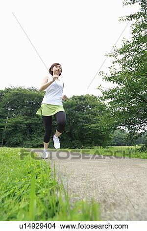 Picture - Young woman running. Fotosearch
