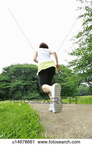 Young woman running View Large Photo Image Stock Image - Young woman running. Fotosearch