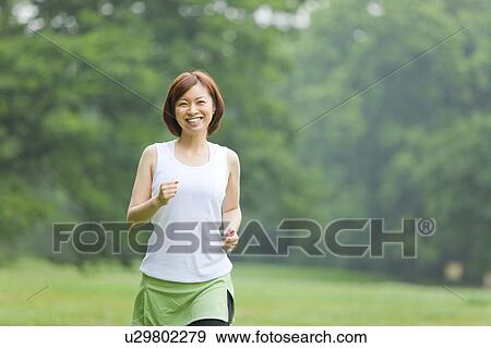Stock Photo - Young woman running. Fotosearch