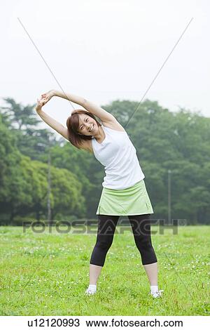 Young woman stretching View Large Photo Image Stock Image - Young woman stretching. Fotosearch