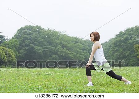 Stock Image - Young woman stretching. Fotosearch