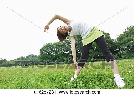 Stock Image - Young woman stretching. Fotosearch