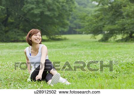 Stock Image - Young woman stretching. Fotosearch