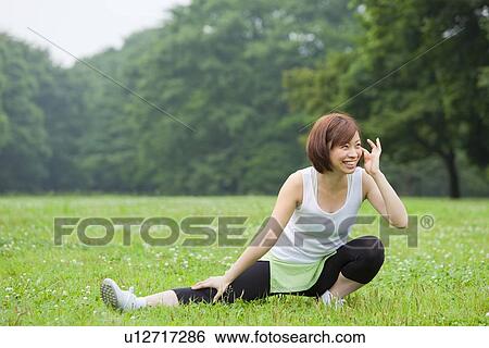 Stock Photograph - Young woman stretching. Fotosearch