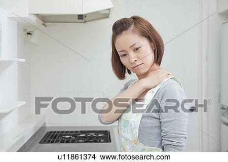 Young woman suffering from pain on shoulder View Large Photo Image Picture - Young woman suffering from pain on shoulder. Fotosearch