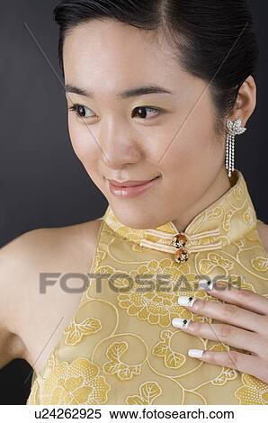Stock Photography - An oriental woman in cheongsam. Fotosearch