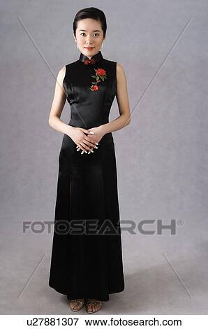 Stock Photo - Young woman in black cheongsam. Fotosearch