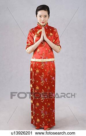 Young woman in cheongsam, hands on chest View Large Photo Image Stock Image - Young woman in cheongsam, hands on chest. Fotosearch
