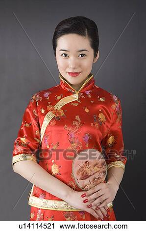 Young woman in cheongsam holding fan View Large Photo Image Stock Image - Young woman in cheongsam holding fan. Fotosearch