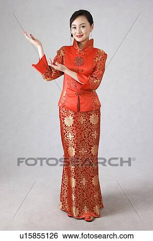 Stock Photograph - Young woman reaching her hands on her right side. Fotosearch